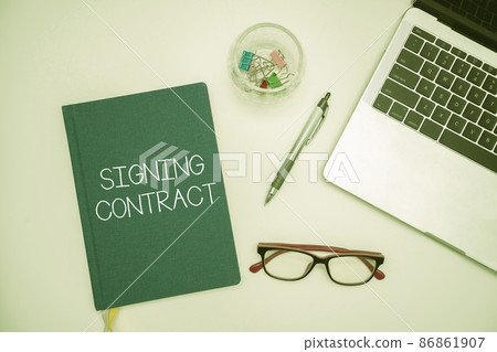 Text caption presenting Signing Contract. Business idea the parties signing the document agree to the terms Office Supplies Over Desk With Keyboard And Glasses And Coffee Cup For Working 86861907