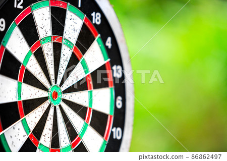 dartboard closeup with blur bokeh of forest background for objective business target, dart board sport and business concept dartboard closeup with blur bokeh of forest background for objective business target, dart board sport and business concept 86862497