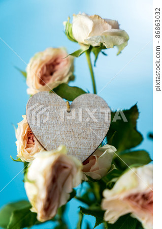 The symbol of the heart in white roses flowers copy the space. Vertical photo The symbol of the heart in white roses flowers copy the space. Vertical photo 86863032