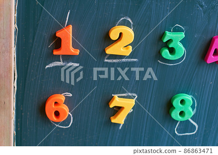 Learning numbers on a blackboard with colorful magnets and handwriting on blackboard during homeschooling at quarantine 86863471