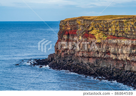 Spectacular steep cliffs with red seams Spectacular steep cliffs with red seams 86864589