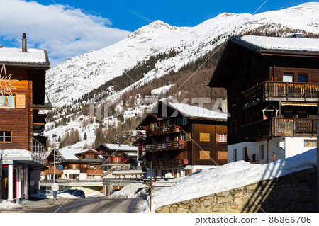 Street view of Bellwald on background of snowy Alps on winter day 86866706