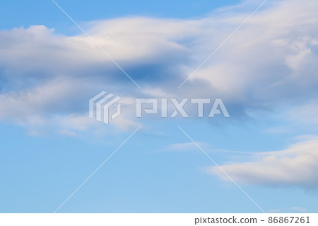 Background of blue sky with white and pink clouds in sunset Background of blue sky with white and pink clouds in sunset 86867261