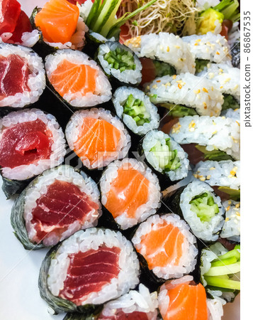 Variety of japanese sushi rolls on a white plate Variety of japanese sushi rolls on a white plate 86867535