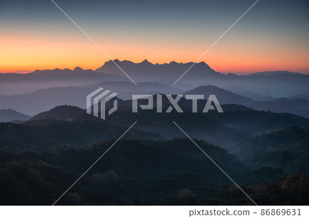 Scenery of Doi Kham Fah viewpoint with sunrise over Doi Luang Chiang Dao mountain with foggy in tropical rainforest at national park Scenery of Doi Kham Fah viewpoint with sunrise over Doi Luang Chiang Dao mountain with foggy in tropical rainforest at national park 86869631