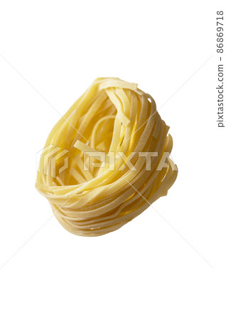 Uncooked fettuccine, noodles pasta nest isolated on white background, levitating food Uncooked fettuccine, noodles pasta nest isolated on white background, levitating food 86869718