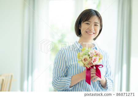 A woman holding a bouquet A woman holding a bouquet 86871271