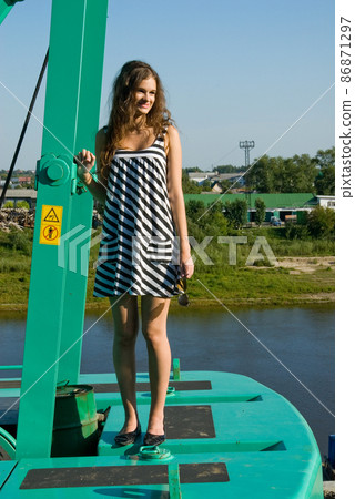 Attractive young woman on construction crane Attractive young woman on construction crane 86871297