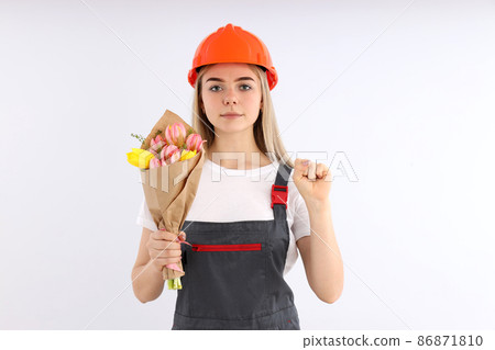 Builder woman with bouquet on white background 86871810