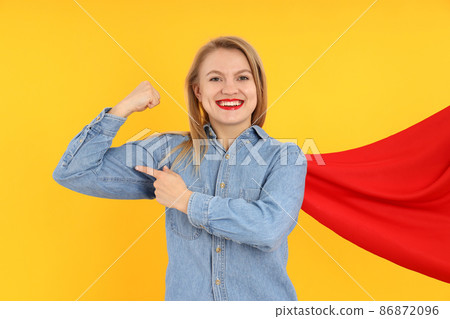Girl power concept with young woman on yellow background 86872096