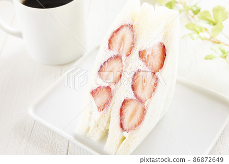 Strawberry sandwich with plenty of whipped cream and hot coffee Strawberry sandwich with plenty of whipped cream and hot coffee 86872649
