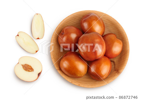 jujube or chinese date in wooden bowl isolated on white background with clipping path. Top view. Flat lay 86872746
