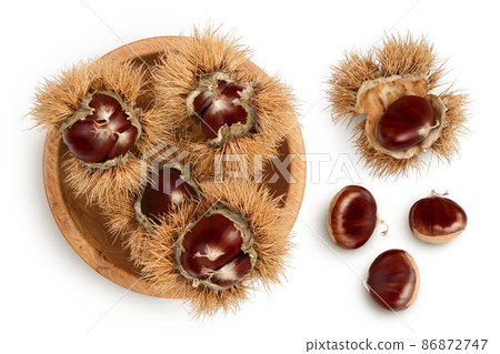 opened sweet chestnut in wooden bowl isolated on white. Top view. Flat lay 86872747