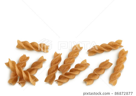 Wolegrain fusilli pasta from durum wheat isolated on white background with clipping path and full depth of field. Top view. Flat lay. 86872877