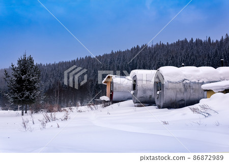 shift camp with cylindrical portable buildings in the winter northern taiga 86872989