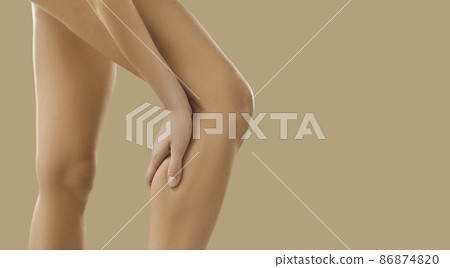 Crop close up image of unhealthy naked woman having ache in leg. Pain in calf concept. Unwell female suffer from acute spasm or cramp. Torn or stretched muscle problem. Healthcare and rehabilitation. Crop close up image of unhealthy naked woman having ache in leg. Pain in calf concept. Unwell female suffer from acute spasm or cramp. Torn or stretched muscle problem. Healthcare and rehabilitation. 86874820