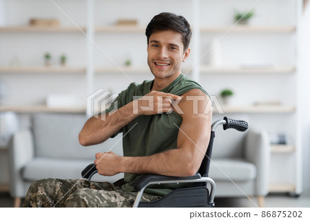 Happy disabled soldier showing band on shoulder and thumb up Happy disabled soldier showing band on shoulder and thumb up 86875202