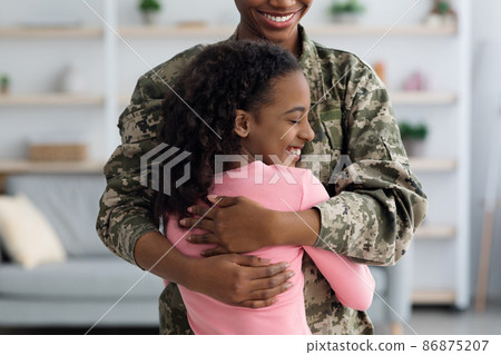 Closeup of african american girl hugging her dad soldier Closeup of african american girl hugging her dad soldier 86875207