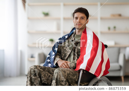 Handsome military guy in wheelchair with flag of the US 86875359
