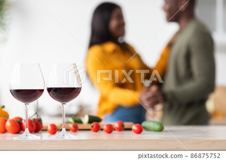 Unrecognizable Black Couple Dancing In Kitchen, Focus On Two Glasses Of Wine Unrecognizable Black Couple Dancing In Kitchen, Focus On Two Glasses Of Wine 86875752