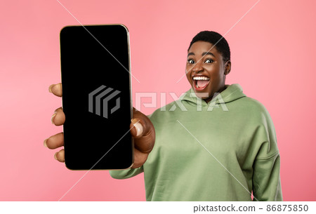 Excited overweight black lady showing smartphone with blank screen 86875850