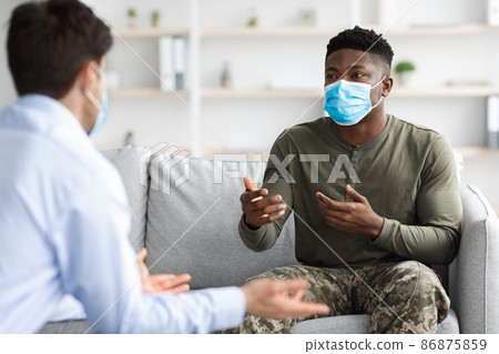 Black soldier in face mask visiting psychologist while pandemic Black soldier in face mask visiting psychologist while pandemic 86875859