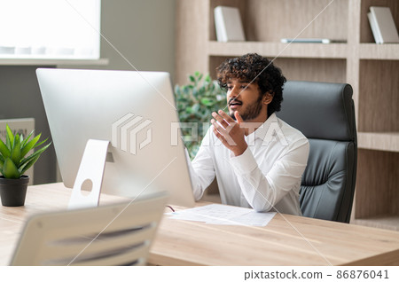 Young indian businessman having a vieo call 86876041