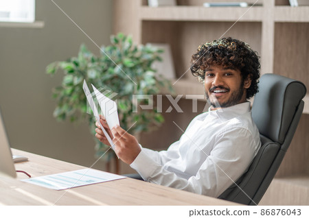 Young indian businessman working in the office Young indian businessman working in the office 86876043