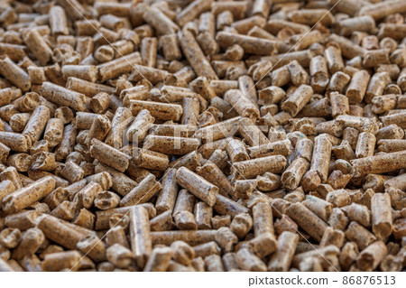 Compacted wooden sawdust pellets. Litter for pets and bio fuel, full frame closeup background with selective focus. Compacted wooden sawdust pellets. Litter for pets and bio fuel, full frame closeup background with selective focus. 86876513