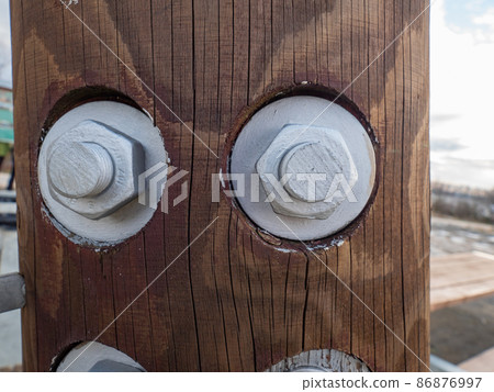 Screw and nut with metric thread. Wooden poles used in construction. Screw and nut with metric thread. Wooden poles used in construction. 86876997