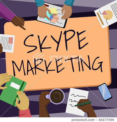 Hand writing sign Skype Marketing. Business showcase apps that specializes in providing video chat and voice Colleagues Office Meeting Having Coffee Discussing Future Projects Charts. 86877090