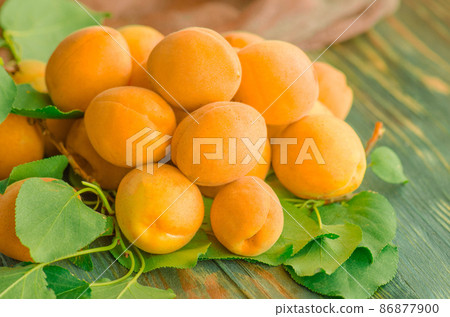 Apricots on wooden table Apricots on wooden table 86877900