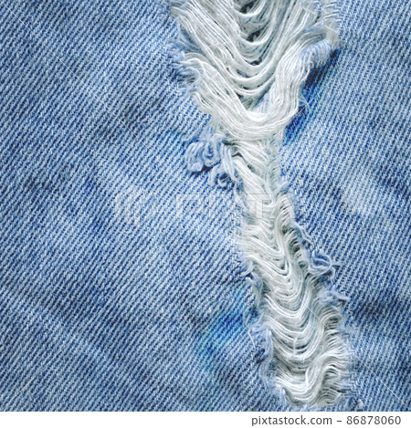 Hole and threads on denim jeans Hole and threads on denim jeans 86878060