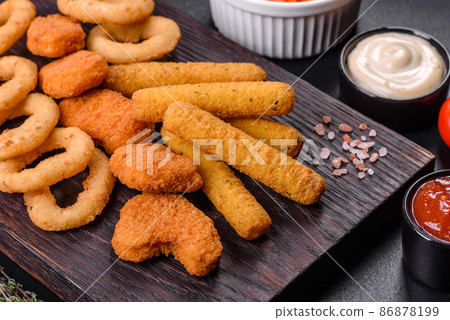 Snack platter - cheese sticks, chicken nugget, onion rings mix of snacks and sauces Snack platter - cheese sticks, chicken nugget, onion rings mix of snacks and sauces 86878199
