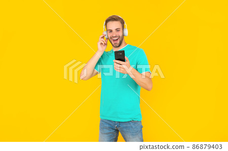 Feel the music you are listening. Happy guy listen to mobile music on phone. Listening to podcast Feel the music you are listening. Happy guy listen to mobile music on phone. Listening to podcast 86879403