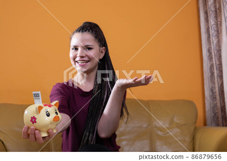 Reasonable planning and saving money are effective after the first year. A happy young teenager because she has learned to plan her expenses well. Reasonable planning and saving money are effective after the first year. A happy young teenager because she has learned to plan her expenses well. 86879656