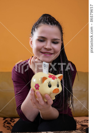 Reasonable planning and saving money are effective after the first year. A happy young teenager because she has learned to plan her expenses well. Reasonable planning and saving money are effective after the first year. A happy young teenager because she has learned to plan her expenses well. 86879657