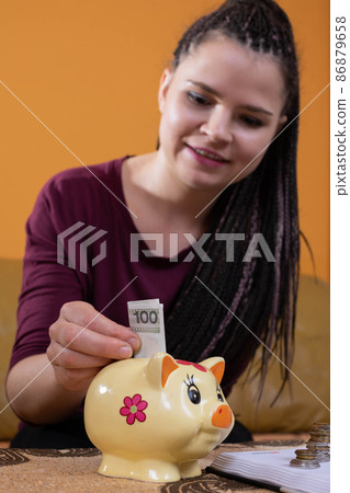 Reasonable planning and saving money are effective after the first year. A happy young teenager because she has learned to plan her expenses well. 86879658