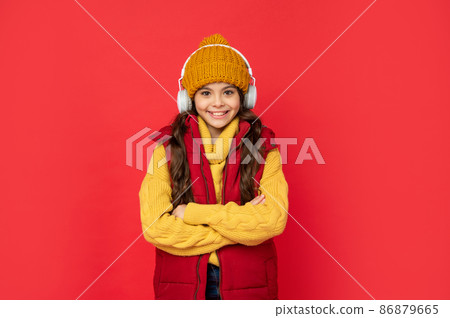 winter fashion. teen girl in hat and earphones. modern life in childhood. winter fashion. teen girl in hat and earphones. modern life in childhood. 86879665