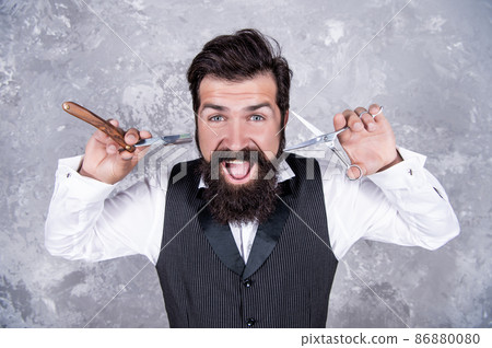 mature bearded man hipster in hairdresser salon with tools of vintage razor and scissors, hairstyle. mature bearded man hipster in hairdresser salon with tools of vintage razor and scissors, hairstyle. 86880080