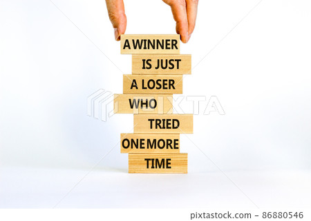 Winner or loser symbol. Wooden blocks with words A winner is just a loser who tried one more time. Beautiful white background, copy space. Businessman hand. Business, winner or loser concept. 86880546
