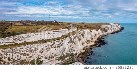 Aerial view of the White Cliffs of Dover. Close up view of the cliffs from the sea side. England, East Sussex. Between France and UK 86881283