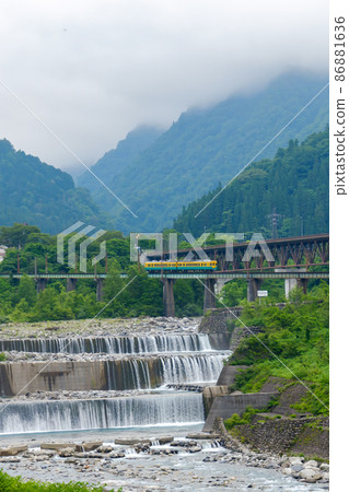 Sabo weir and ground railway train of Toyama / Joganji River 86881636