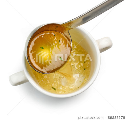 chicken broth pouring into bowl chicken broth pouring into bowl 86882276
