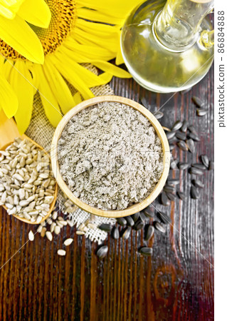 Flour sunflower in bowl with flower on board top Flour sunflower in bowl with flower on board top 86884888