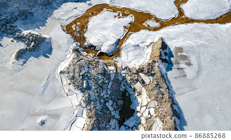 Aerial over melting snow at rock quarry Aerial over melting snow at rock quarry 86885268