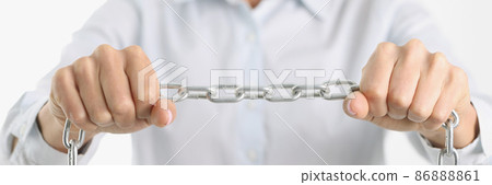 Businessman firmly holds chrome chain in hands Businessman firmly holds chrome chain in hands 86888861