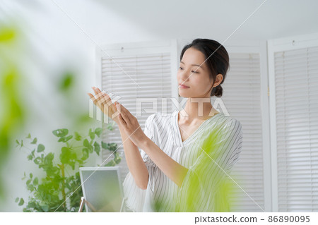 A woman doing hand care A woman doing hand care 86890095