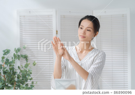 A woman doing hand care A woman doing hand care 86890096