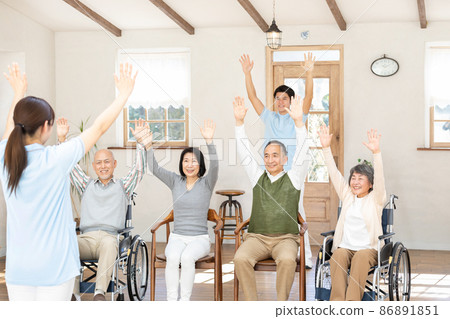 Seniors and healthcare professionals doing gymnastics in nursing homes 86891851